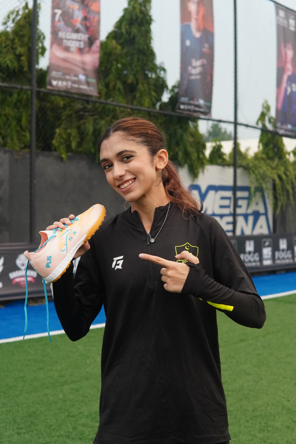 Sibal holding a peach LYNX PL15 on the pitch