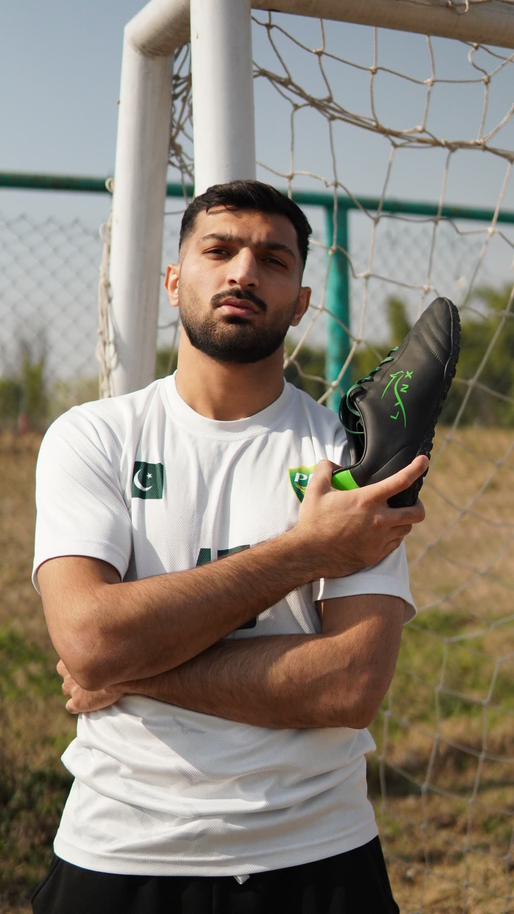 Abdullah Shah in Pakistan national kit holding a black LYNX PL15